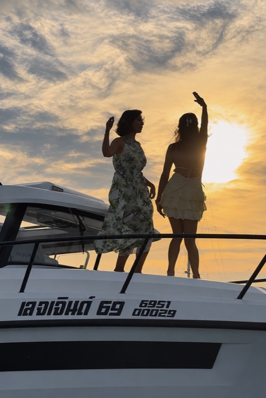 Two guests enjoying sunset on a boat