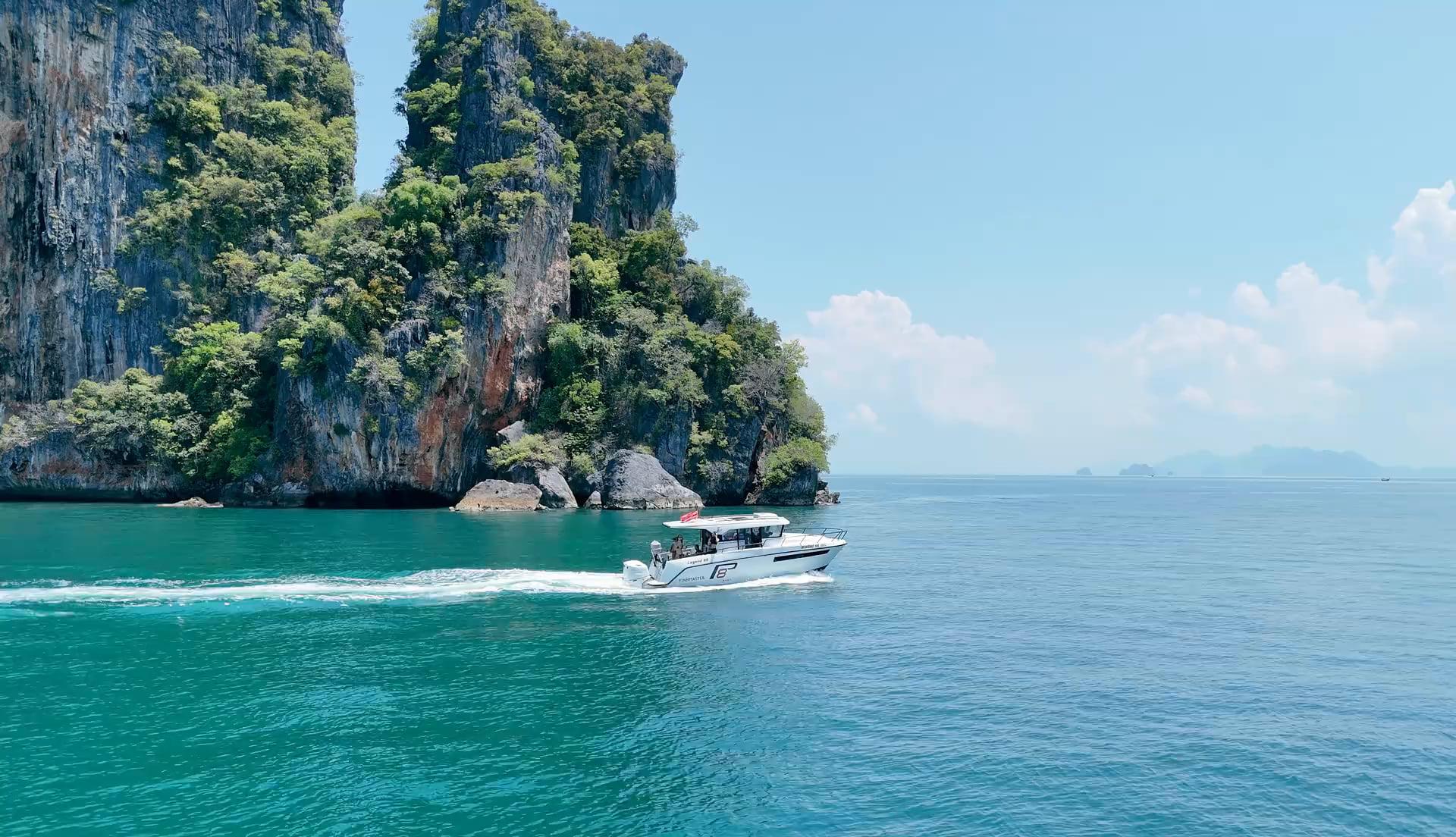 Finnmaster Pilot passing limestone cliffs on the Andaman Sea.