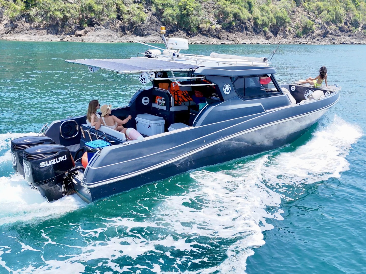 Guests on the shaded open deck of the Silvercraft 36HT at sea