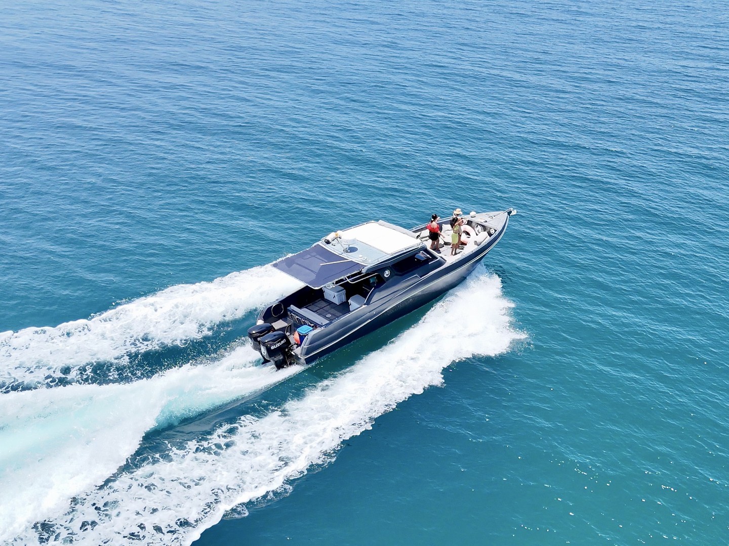 Three-quarter aerial view of the Silvercraft 36HT cruising with a wake