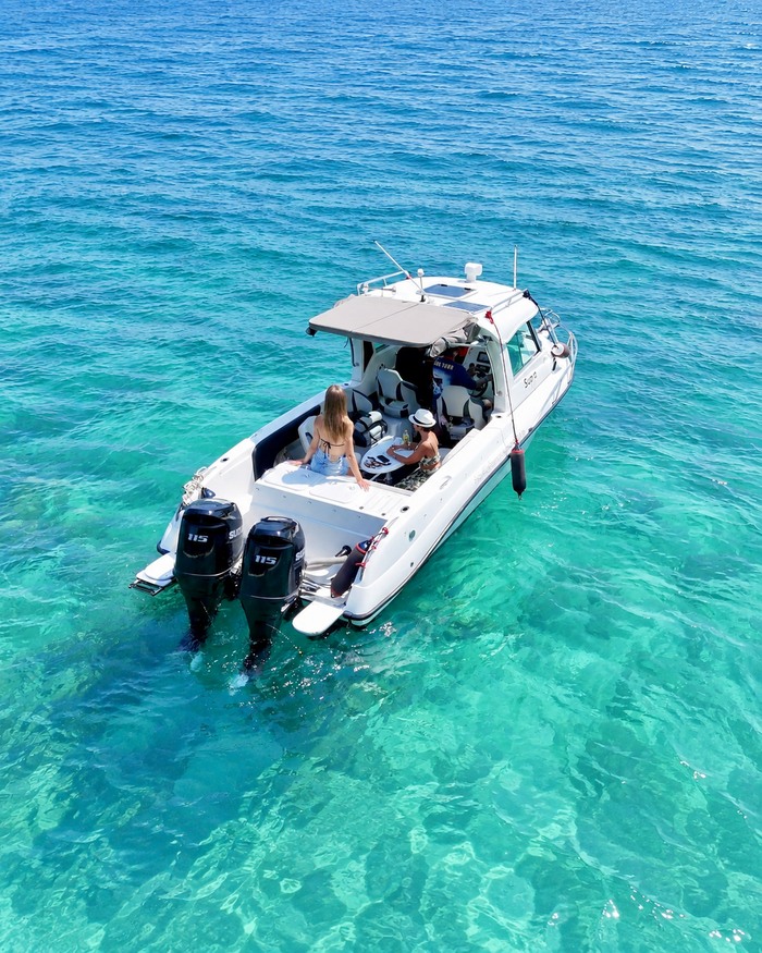 A complete AquaTour boat seen from above in clear turquoise water