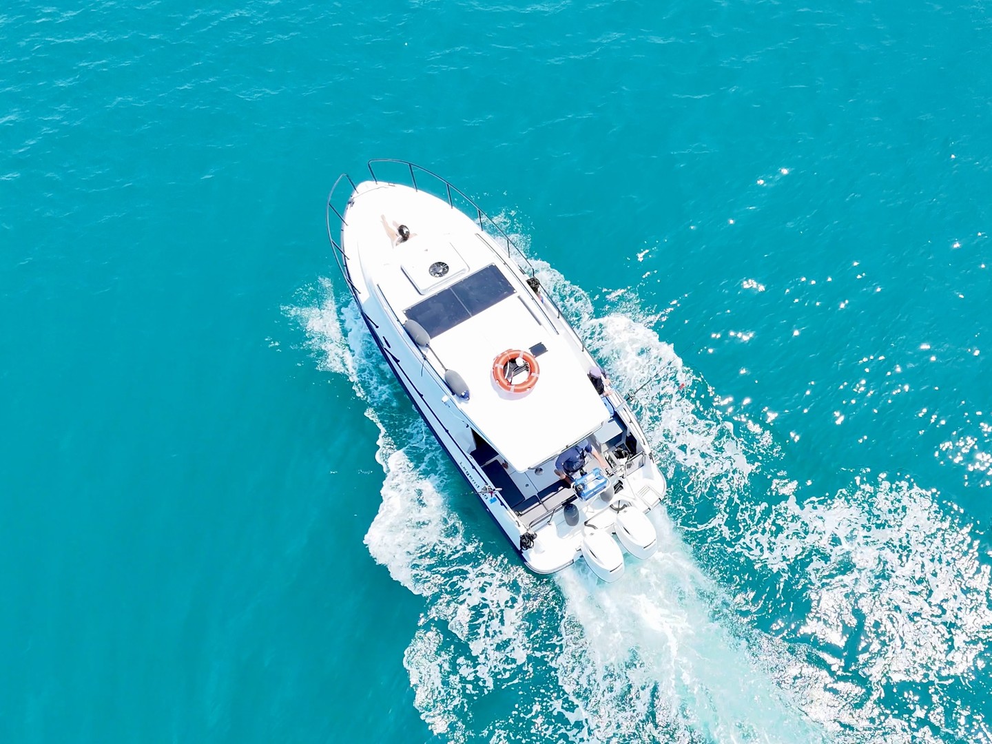 Aerial top-down of the Finnmaster Pilot cruising through turquoise water
