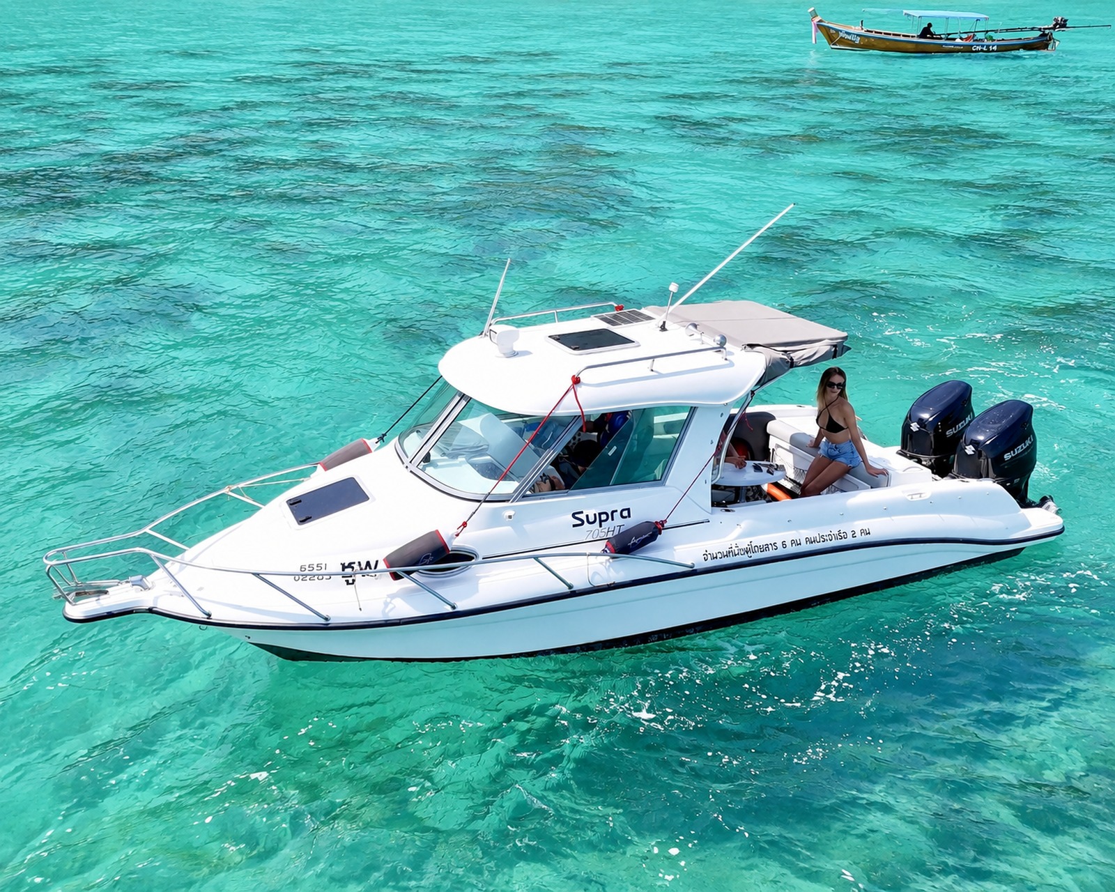 Close side view of Atomix 705HT with a person seated on the rear deck.