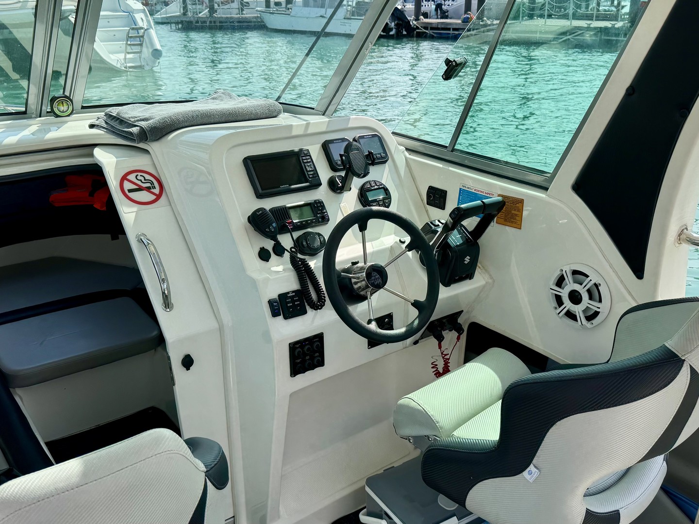 Steering wheel, controls and helm seat aboard Atomix 705HT.
