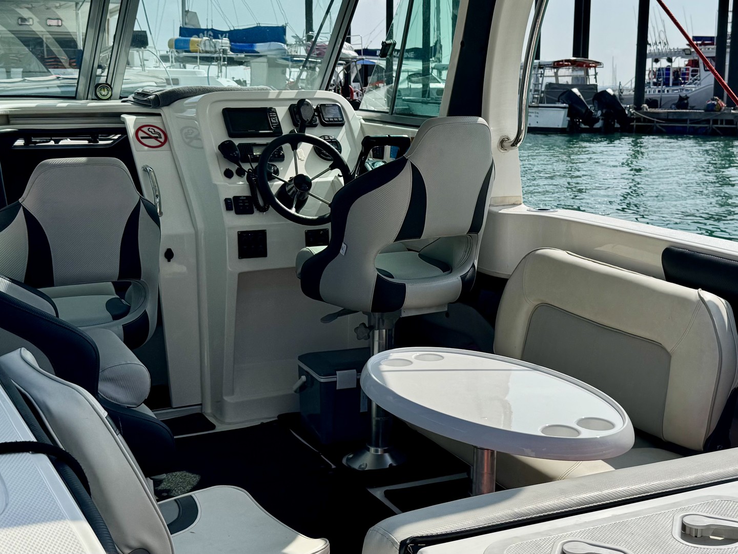 Seating and a table inside the cockpit of Atomix 705HT.
